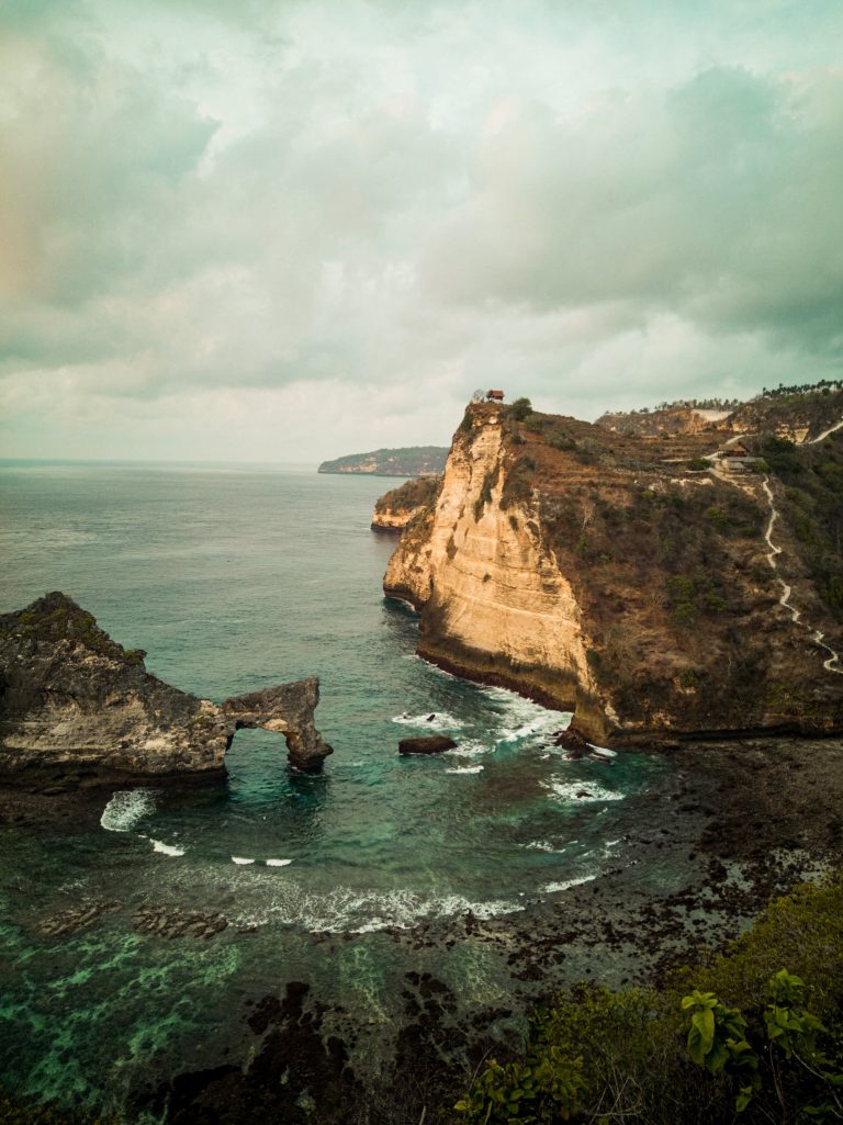 View over the arched rock at Atuh beach