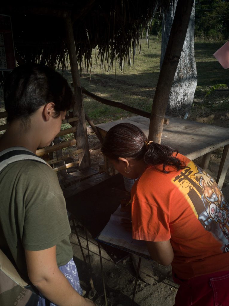 A local collecting a fee upon entry to Locong Falls