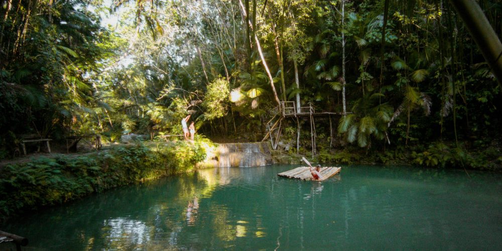 A local pulls himself ashore on a bamboo raft