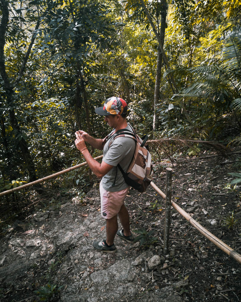 There is a raw dirt trail leading down to the waterfall