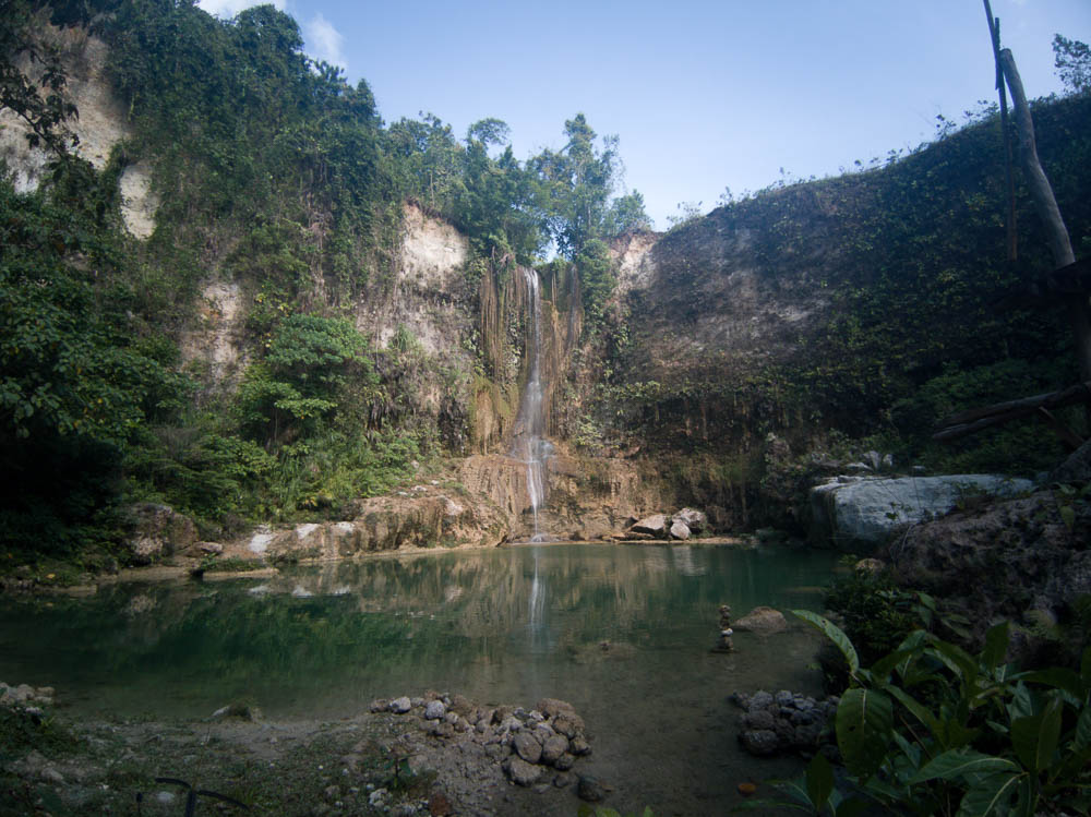 Camugao Falls plunging into a vibrant blue pool