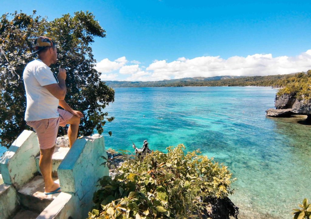 Looking onto crystal clear emerald waters surrounded in lush greenery