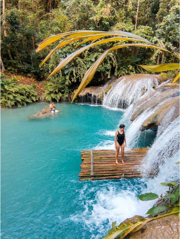 Jacqueline next to a cascade in Siquijor with turquoise water