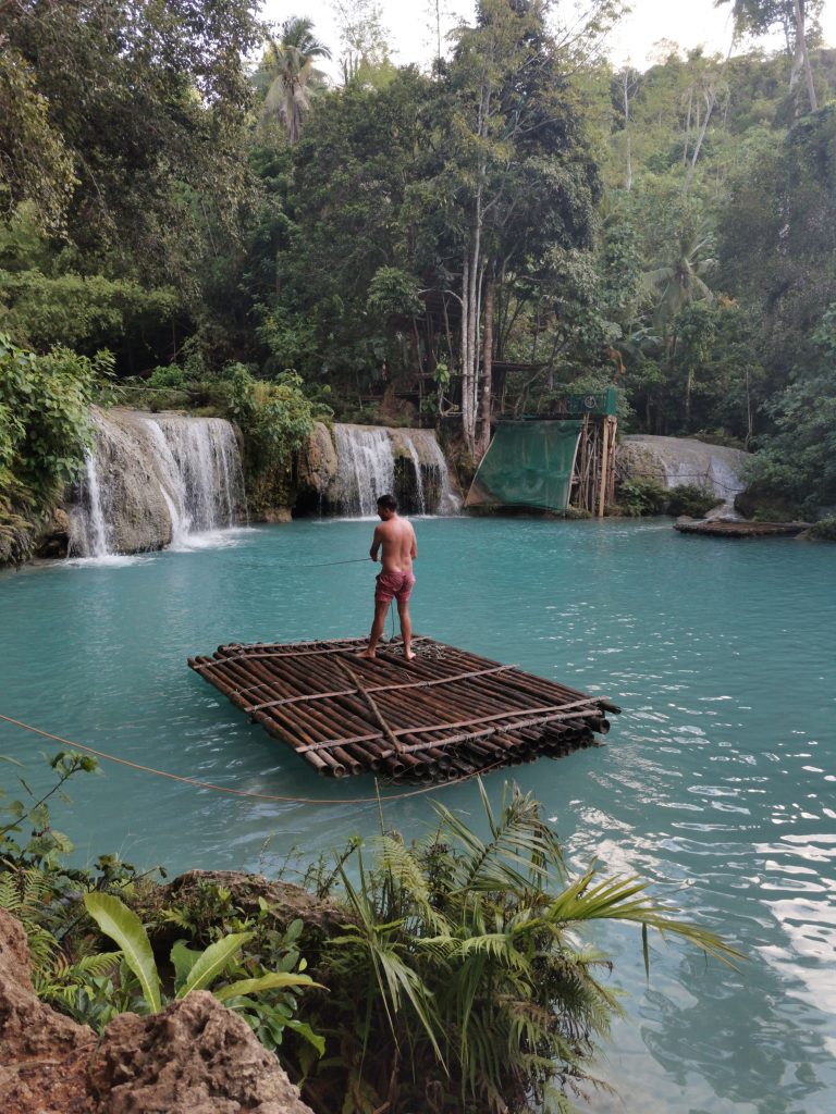 James on a barge heading to the fall at Cambugahay falls, siquijor