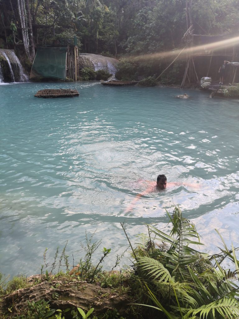 James swimming in the milky blue waters at Cambugahay Fall Siquijor