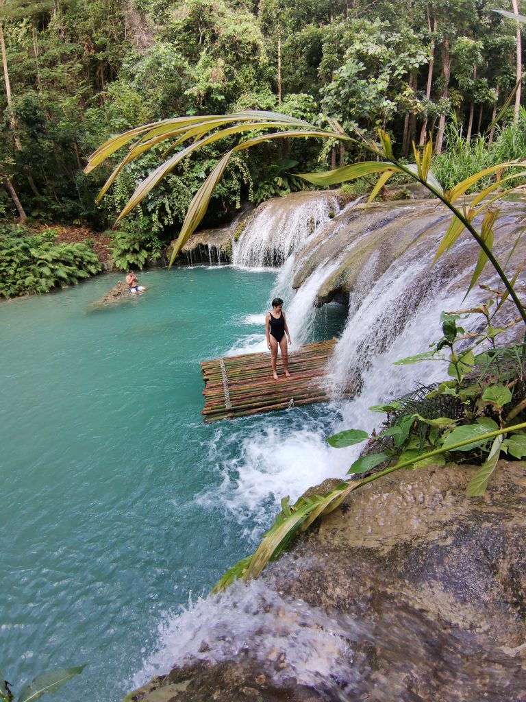 Jacqueline on a barge under the fall at Cambugahay falls third level