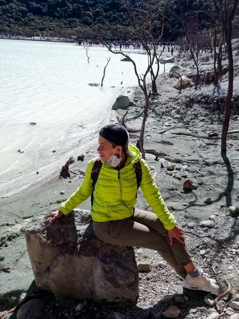 Jacqueline sitting on a rock near the acidic lake.