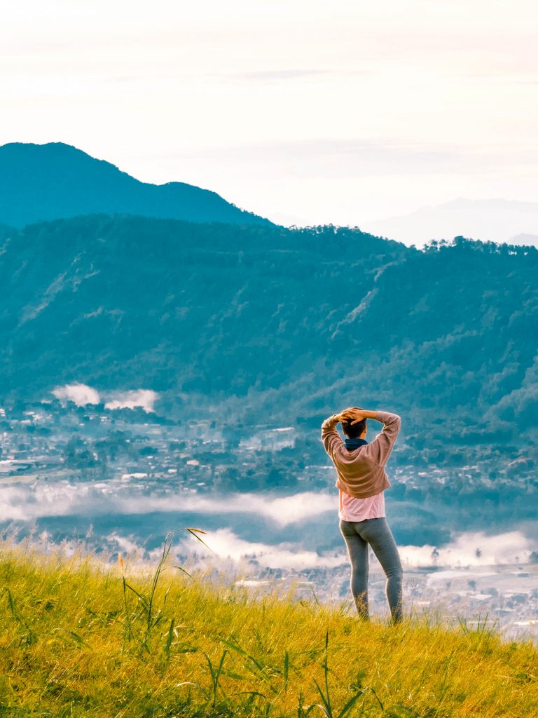 Jacqueline on putri mountain blurred out and the image focuses on the mountains in the background