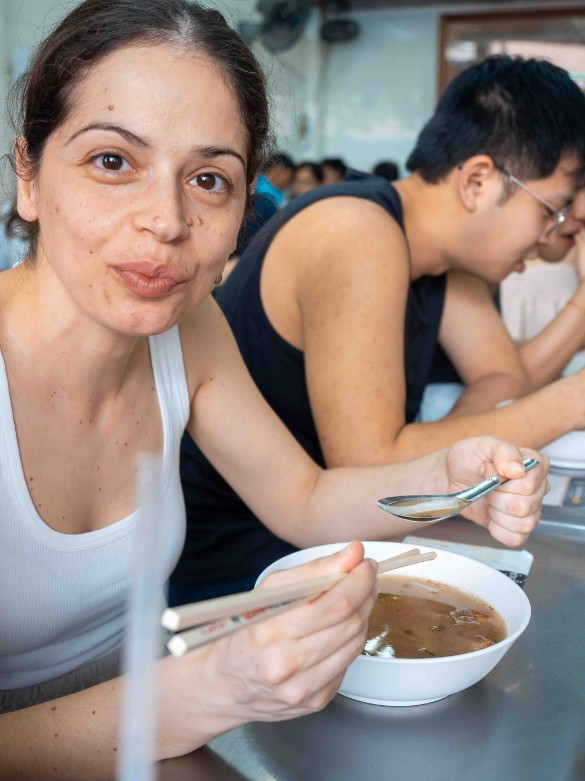 Jacqueline eating a delicious nei ek roll noodle
