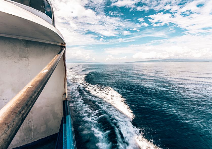 Sideview of a boat riding through the ocean