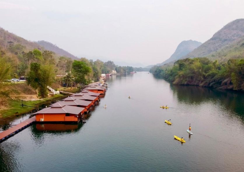 Floating bungalows in a lake surrounded by jungle and mountains