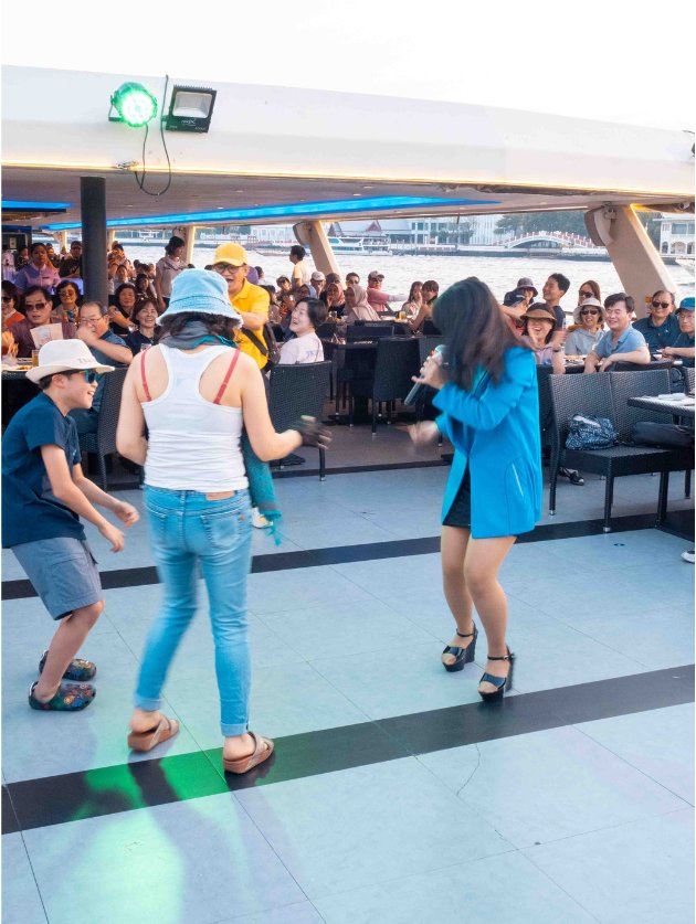 A group of Asian women and kids dancing