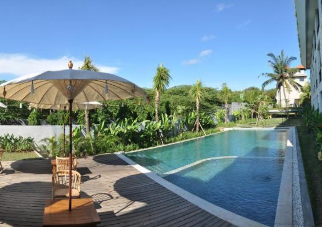 A pool surrounded by tropical garden