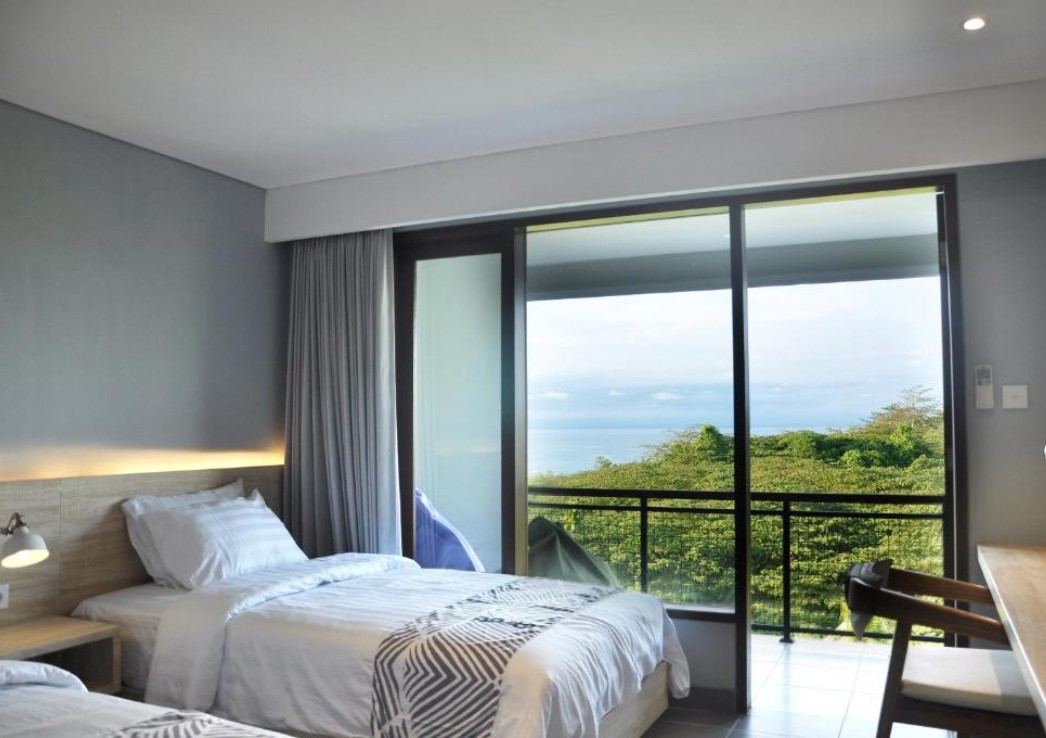 A room with terrace overlooking a lush landscape