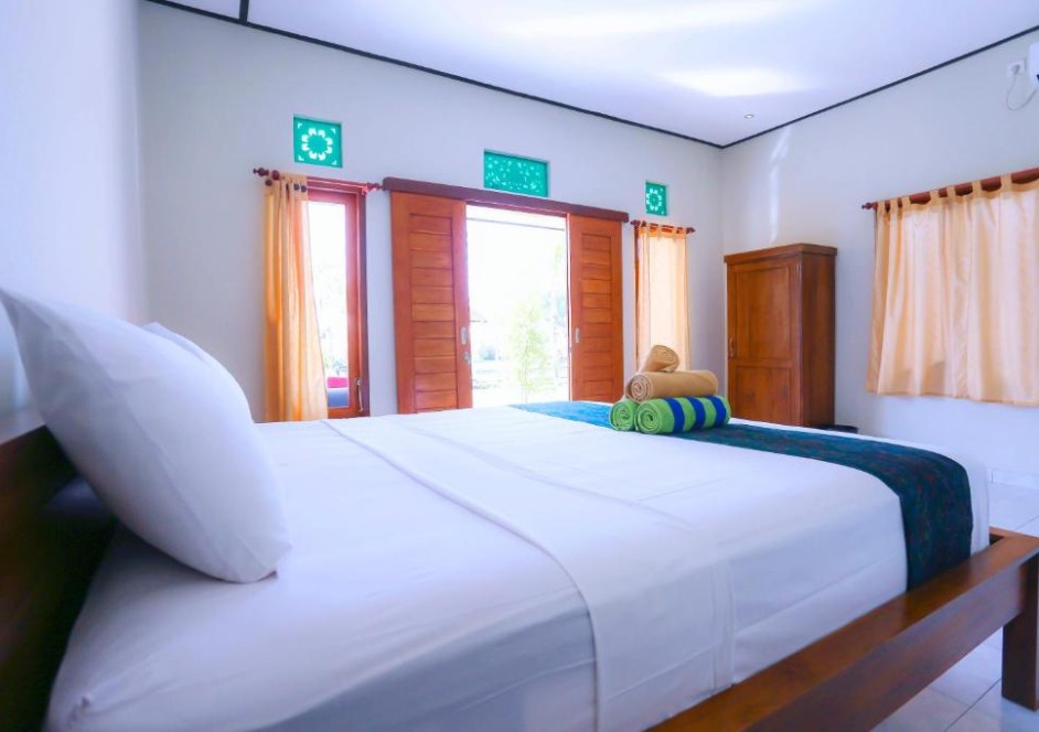 A simple suite room with white linen bed