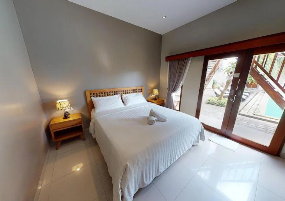 A basic room with a bed and a terrace