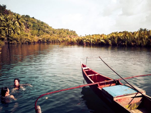 Jacqueline and a new Filipino friend that we made on the barge at the Secret Lagoon next to a wooden boat